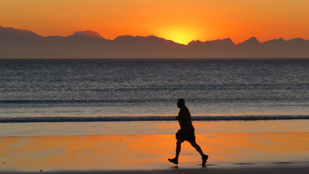 Runner on the beach at sunset