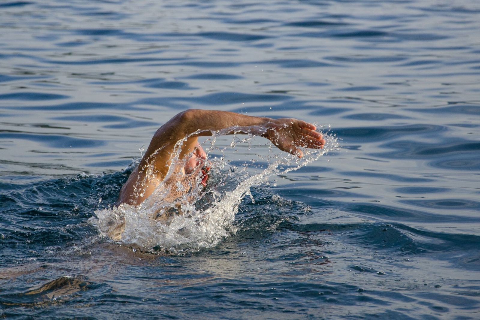 Swimmer mid-stroke in open water